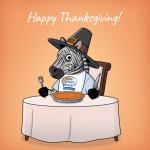 Rarity the zebra wearing a pilgrim's hat at a Thanksgiving table